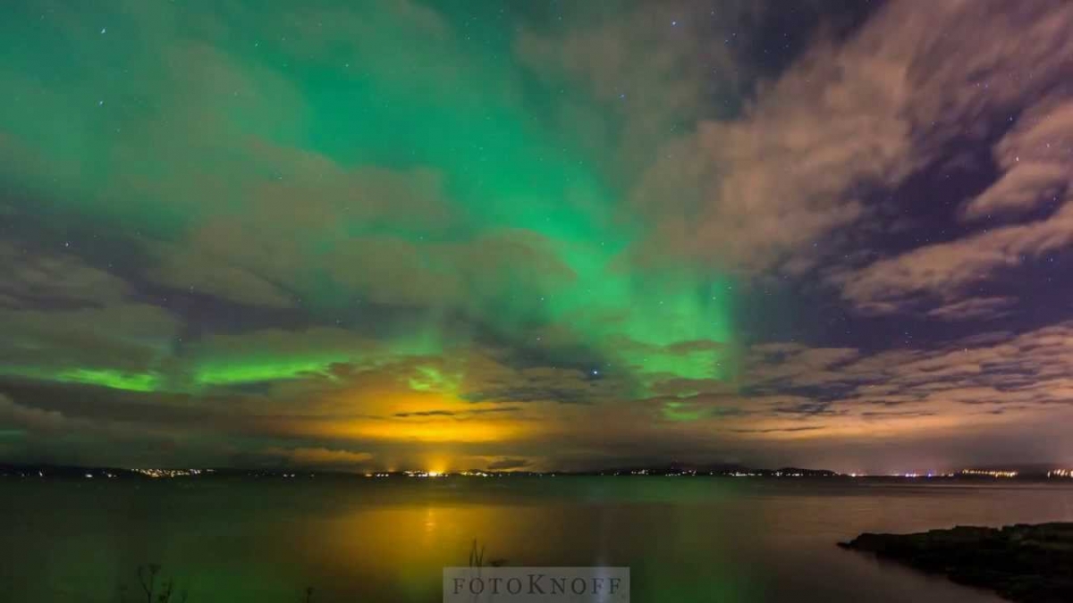 Aurora Borealis; Northern Lights in Trondheim Fjord and Trondheim, Norway, October 30. 2013
